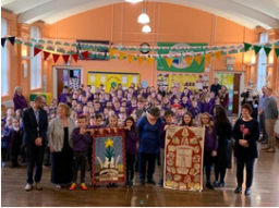 Ysgol Cwmgors (Cwmgors School) staff and students with their Saint David's Day banner