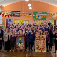 School children and Gwenno Dafydd with St David's Day banner