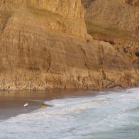 Surfers on Fall Bay
