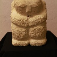 sitting figure stone