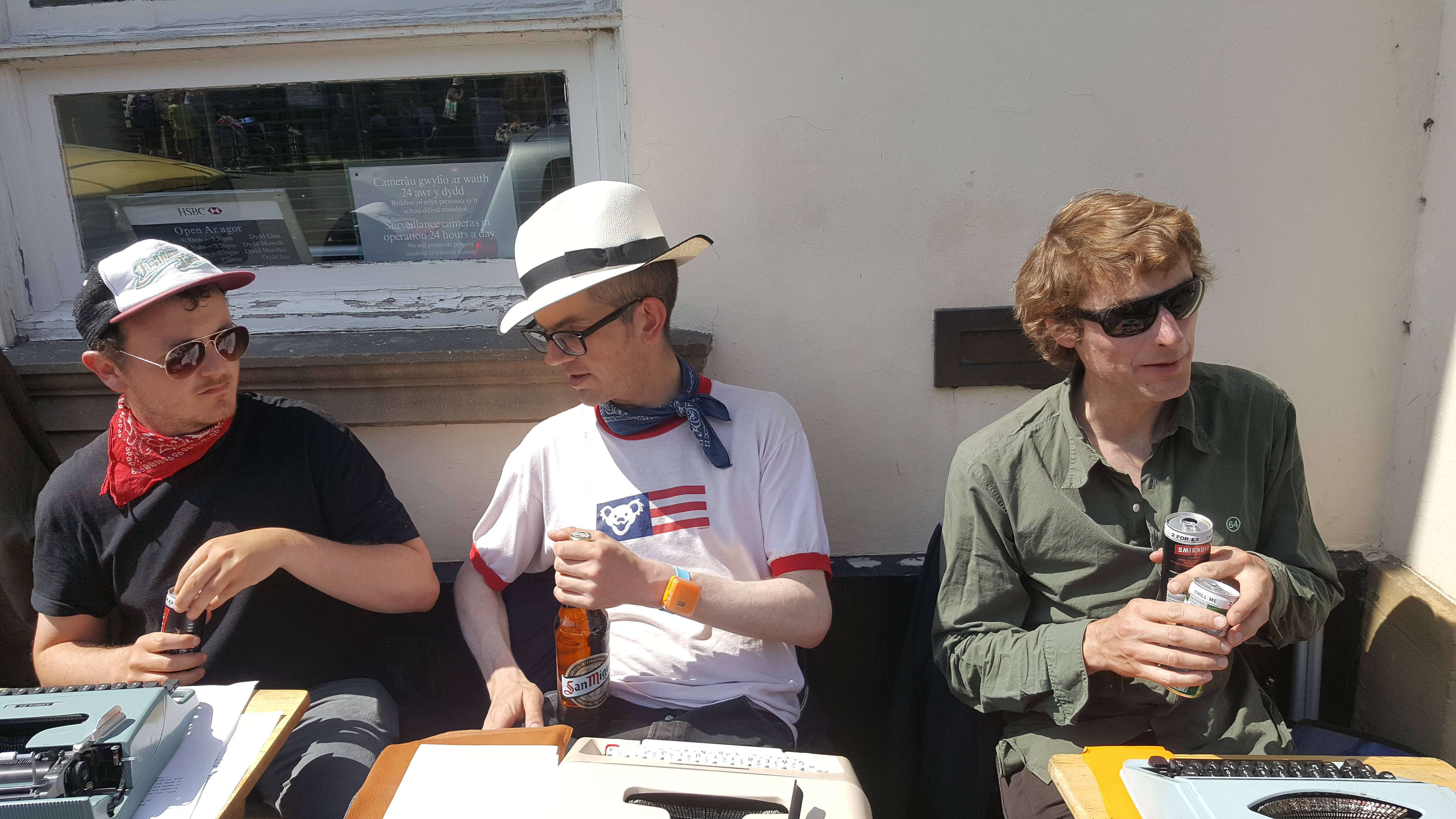 three sidewalk poets at Hay-on-Wye